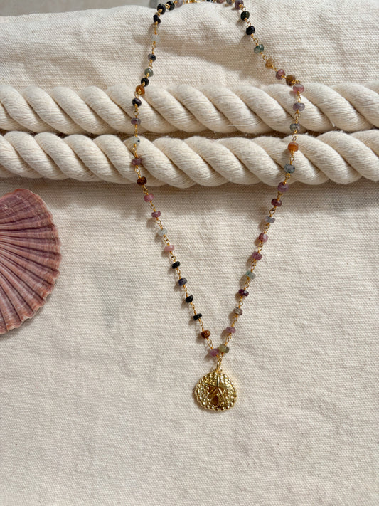 Deepwater Relic – Gold Sand Dollar Necklace (Tanzanite Beaded, 20”)